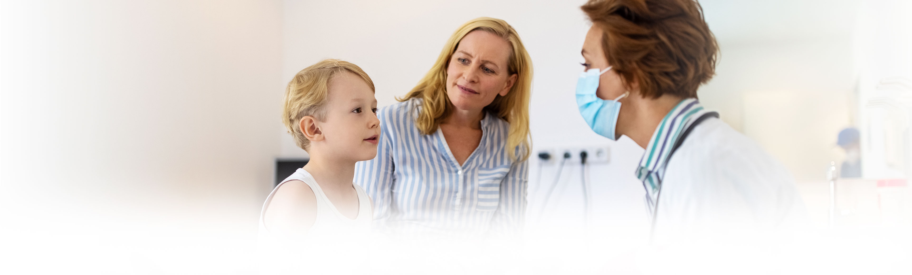 Mother and son sitting in front of doctor