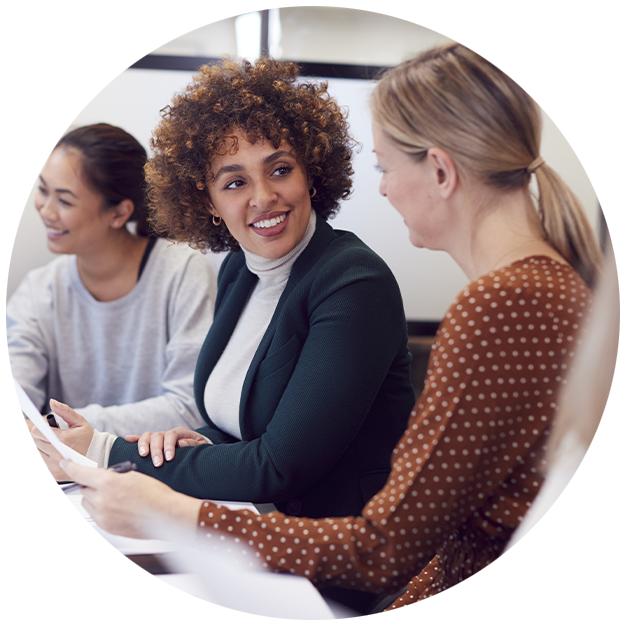 Woman smiling at another woman in office setting